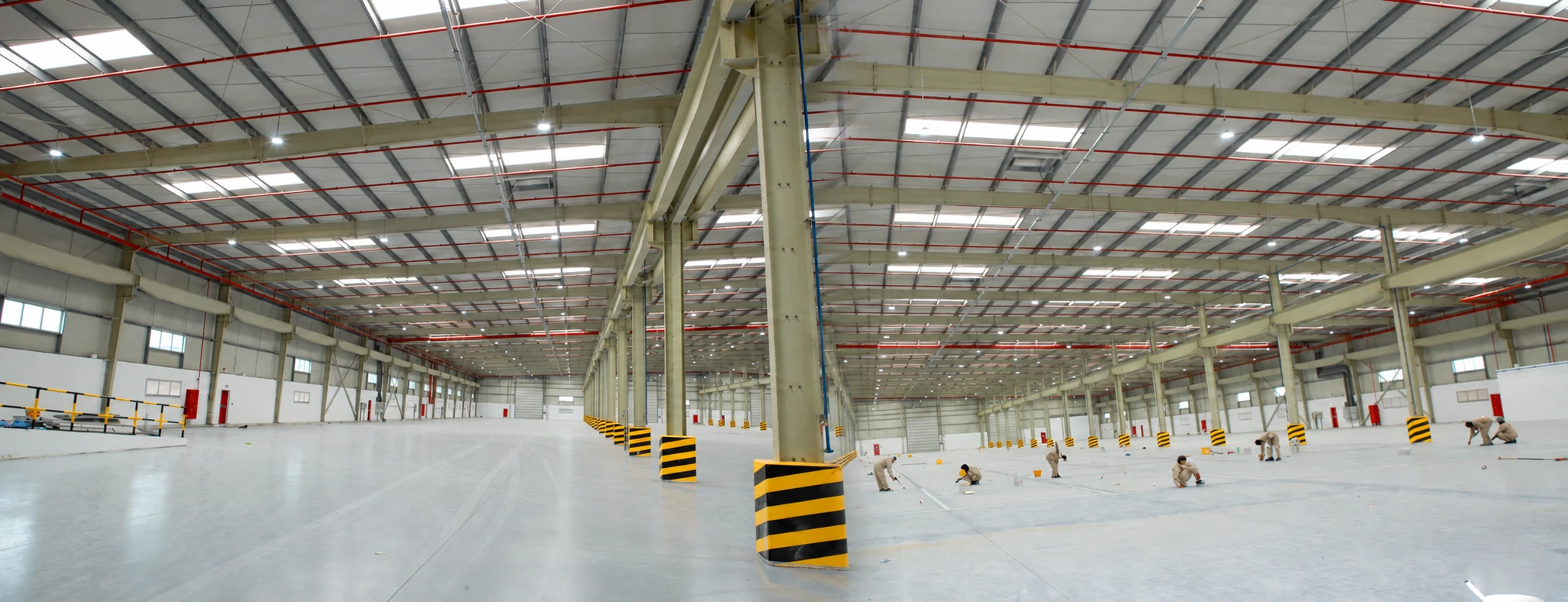 Completed building interior showing roof framing and protected columns